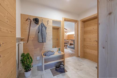 a room with wooden walls and a hallway with a closet at Haus Pötzes in Castelrotto