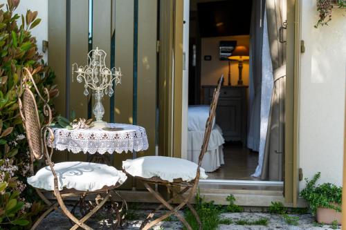 a table and chairs in front of a door at Casina Le Conserve in Cesenatico