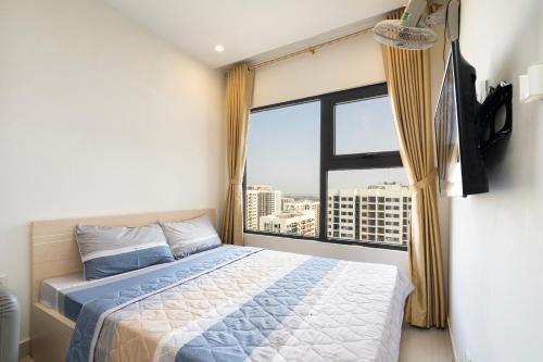 um quarto com uma cama e uma grande janela em Shi House - Studios Toà S503 Vinhomes Grand Park Q9 em Long Bình
