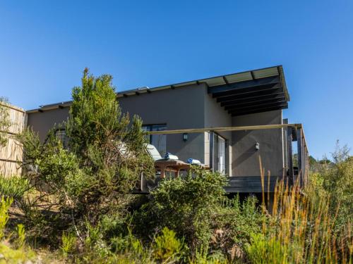 a house on the side of a hill at Cliffside Suites in Plettenberg Bay