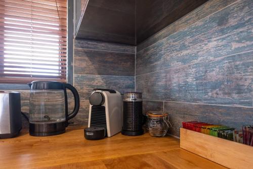a kitchen counter with a coffeemaker and a coffee maker at Private Rural Solace at Saje Farm in Cooks Gap in Mudgee