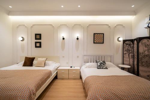 Ένα ή περισσότερα κρεβάτια σε δωμάτιο στο Shanghai Downtown Yidu B&B - Near People's Square Metro Station