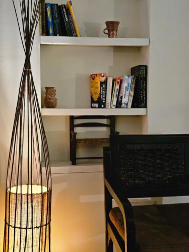 a room with a desk and a chair and a shelf with books at BE Jardin Escondido By Coppola in Buenos Aires