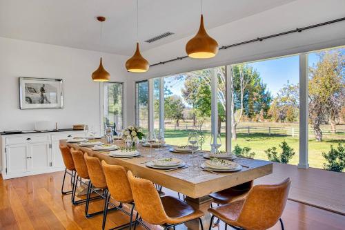 a large dining room with a table and chairs at 'Bonnie View' A Magnificently Luxurious Retreat in Mudgee