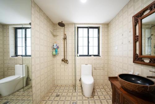 a bathroom with a sink and a toilet and a tub at Shanghai Downtown Yidu B&B - Near South Shaanxi Road Metro Station in Shanghai