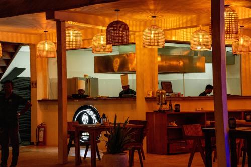 a restaurant with a table and chairs and a mirror at Peacock Beach Hotel Unawatuna in Unawatuna