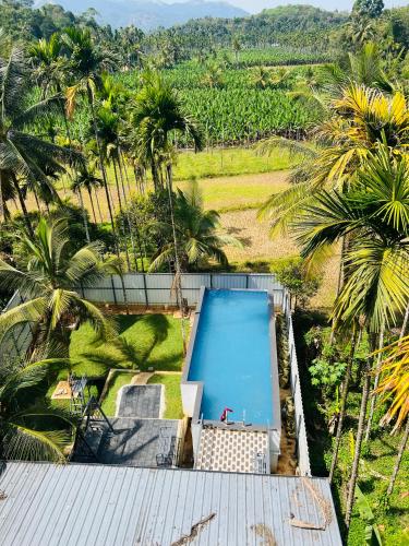 an overhead view of a swimming pool on top of a house at Leisure familyvillas in Padinjarathara