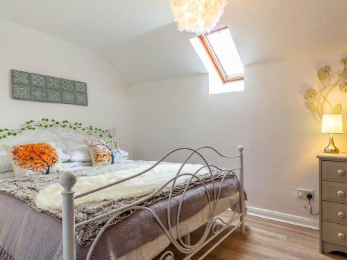 um quarto com uma cama e uma clarabóia em 2 Bed in South Molton 78302 em Kings Nympton