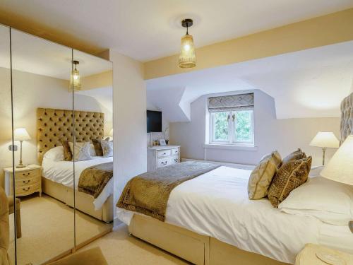 a bedroom with two beds and a window at 3 Bed in Cartmel 66725 in Holker