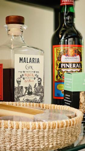 a bottle of marmalaria gin and a bottle of wine at BE Jardin Escondido By Coppola in Buenos Aires