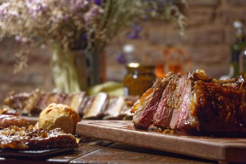 a table topped with cuts of meat and bread at BE Jardin Escondido By Coppola in Buenos Aires