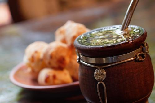 a jar of dipping sauce next to a plate of food at BE Jardin Escondido By Coppola in Buenos Aires