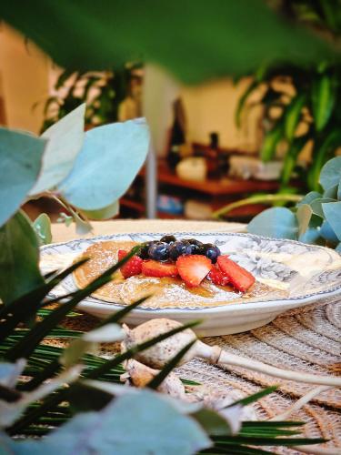 a plate of food with fruit on a table at BE Jardin Escondido By Coppola in Buenos Aires