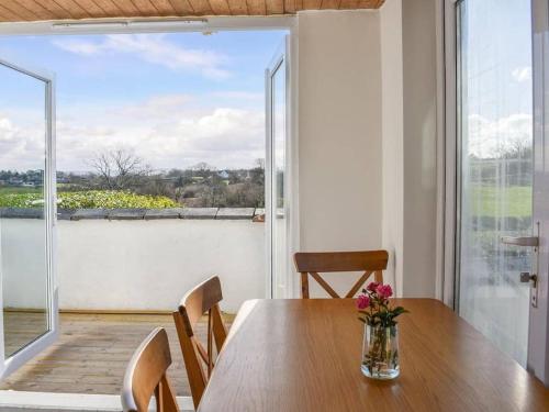 a dining room with a table and a large window at Bron Haul, Mountain Views in Brynteg