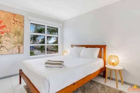 um quarto branco com uma cama e uma janela em The heart of Cairns City with panoramic views em Cairns