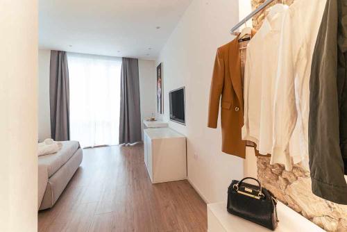 a room with a living room with a suit on a rack at CeO LUXURY SUITE DI CAGLIARI in Cagliari
