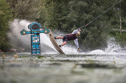 a man water skiing on a board in the water at Pura Vida Workation & Ferienwohnung in Fischen