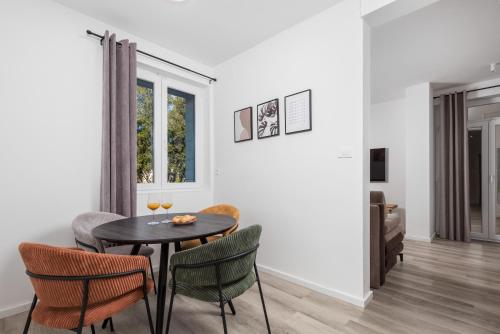 a dining room with a table and chairs at Brand new apartments Villa Tereza Icici, 100m from the beach in Ičići