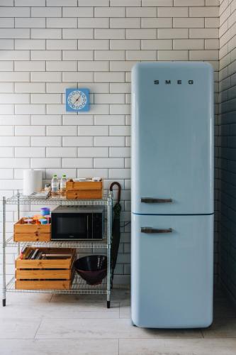 a white refrigerator in a kitchen with a microwave at Zima Blue in Zygi