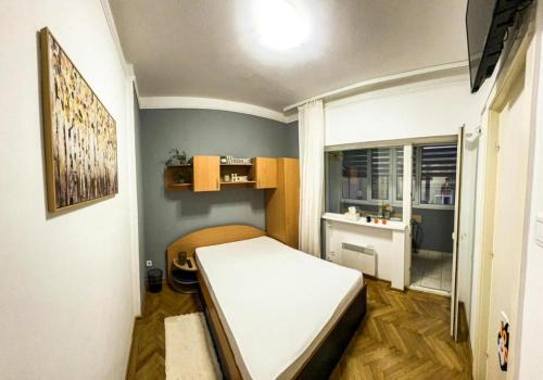 a small room with a bed and a sink at Welcoming Central Studio with self check in in Bucharest