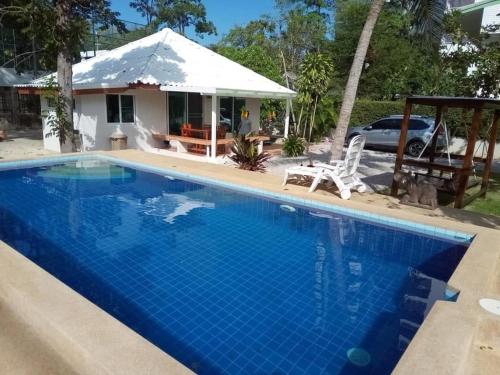 a villa with a swimming pool and a house at Nicha Pool Villa in Hua Hin