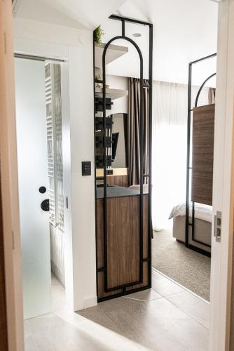 a mirror in a room with a bedroom at RIVA sleep & chill in Valjevo