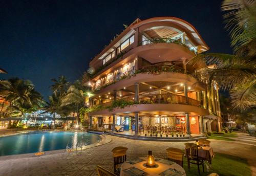 a building with a swimming pool next to a resort at Uday Samudra Leisure Beach Hotel & Spa in Kovalam