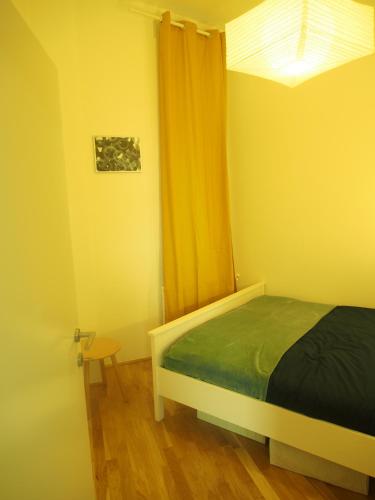 1 dormitorio con 1 cama y una ventana con cortinas en Nähe Naschmarkt en Viena