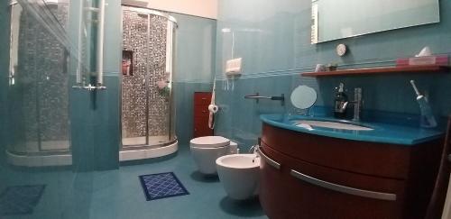 a bathroom with a sink and a shower and a toilet at Appartamento Trinacria in Palermo