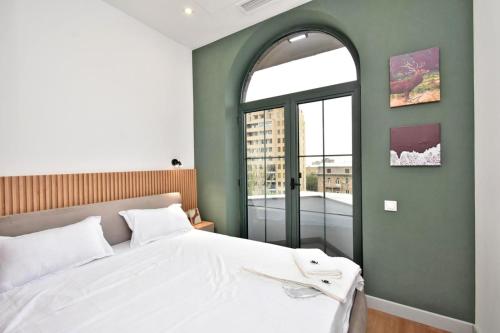 a bedroom with a white bed and a window at Aygestan plaza apartment 5 in Yerevan