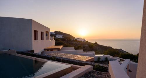 a sunset view of a house with a swimming pool at 11:11 By Potnia in Akrotiri