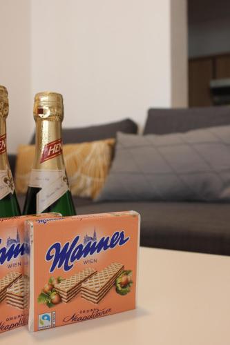 two bottles of beer sitting on a table at Little City Center Golden Roof 12 in Innsbruck