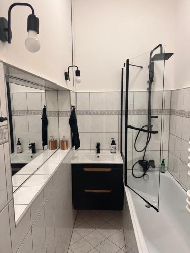 łazienka z 2 umywalkami i dużym lustrem w obiekcie Red Bike Apart's w mieście Opole