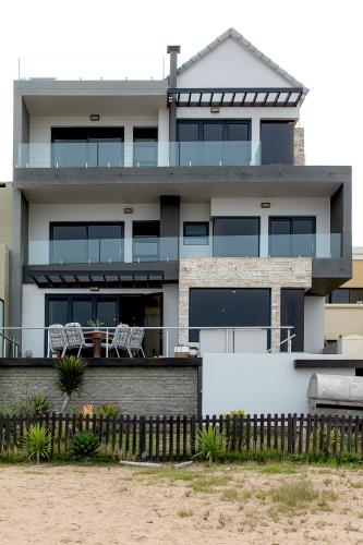a house with a fence in front of it at Flamingo Beach in Swakopmund