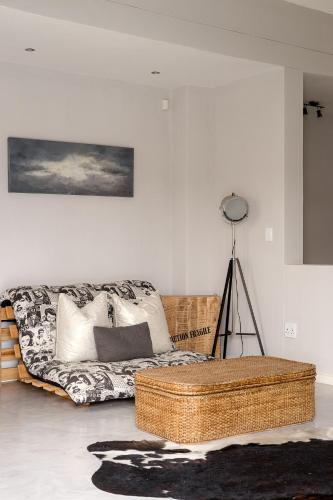a living room with a wicker couch in a room at Flamingo Beach in Swakopmund