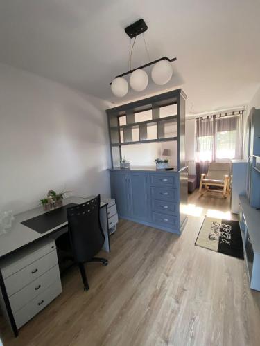 an office with a blue cabinet and a desk at Motel Dacia in Sebeş