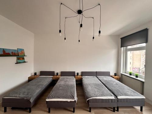 a dining room with two beds and a chandelier at Red Bike Apart's in Opole