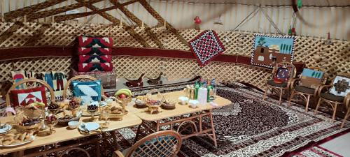 a room with a table and chairs with christmas decorations at KARAKALPAK ETNO VILLAGE in Nukus