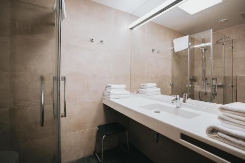 a bathroom with a sink and a shower at St Michael Alpin Retreat in Matrei am Brenner