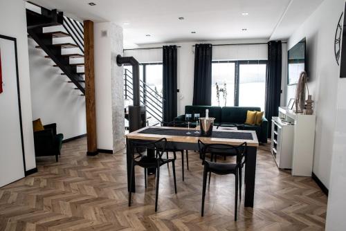 a living room with a table and chairs and a couch at Noclegi Beskidzkie Stodoły in Odrzechowa