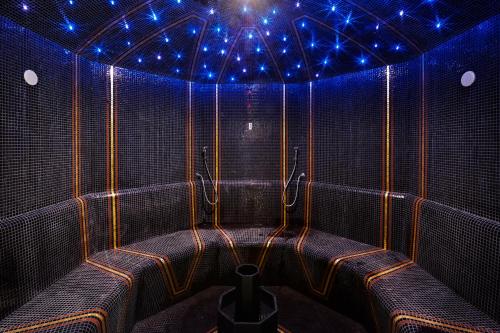 a room with blue lights on the ceiling at Guarda Golf Hotel & Residences in Crans-Montana