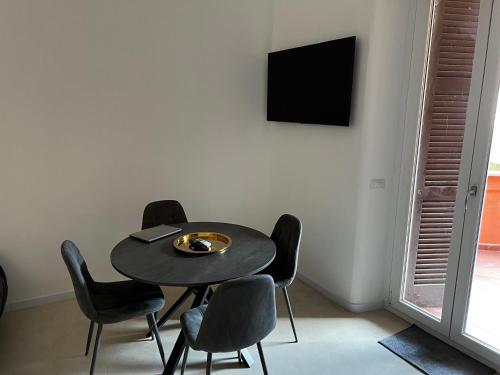 a dining room with a black table and chairs at Love4Rome Guest House in Rome