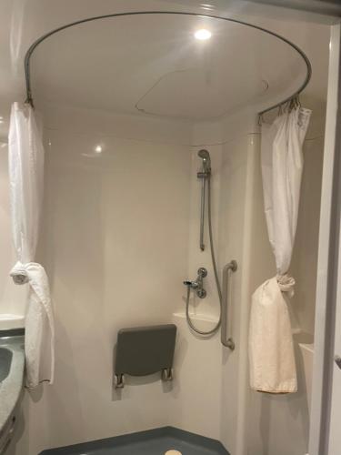 a bathroom with a shower with a sink and a toilet at Hostel Van Gogh in Brussels