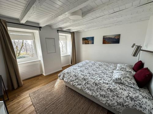 a bedroom with a bed and a window at Domaine du Deven Grandvaux in Grandvaux