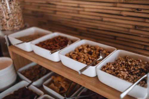 a shelf with several trays of food on a table at Adama Mykonos Boutique Hotel in Mýkonos City