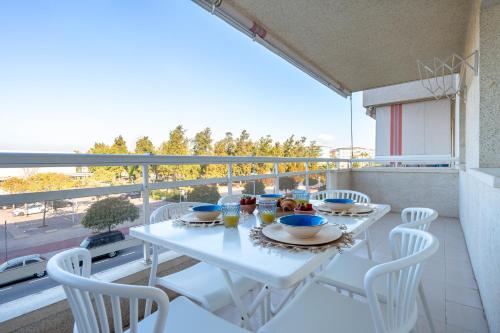 a white table and chairs on a balcony at Alea Rentals - Acquamarina in La Pineda