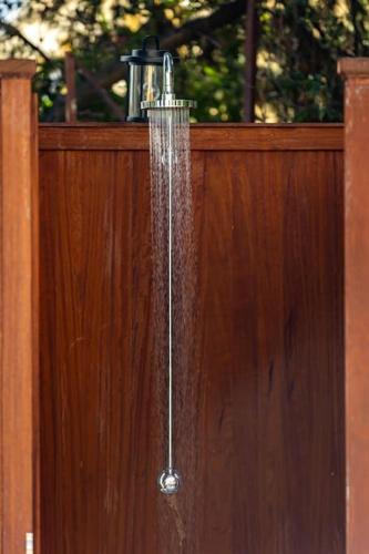 a shower with water coming out of a wooden fence at Villa Isabelle with superb views in Lygia