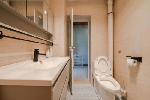 a bathroom with a toilet and a sink at Arthur's Roof-Top in Chengdu