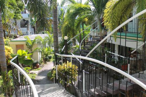 a gate in front of a building with palm trees at Turtle Inn Resort in Boracay