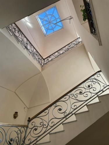 a staircase with a blue window on the ceiling at Villa Aura in Torre del Greco